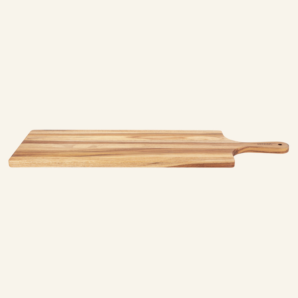 Teak cheese board styled with a charcuterie spread on a dining table