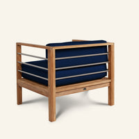 Wooden armchair with blue cushions on a white background